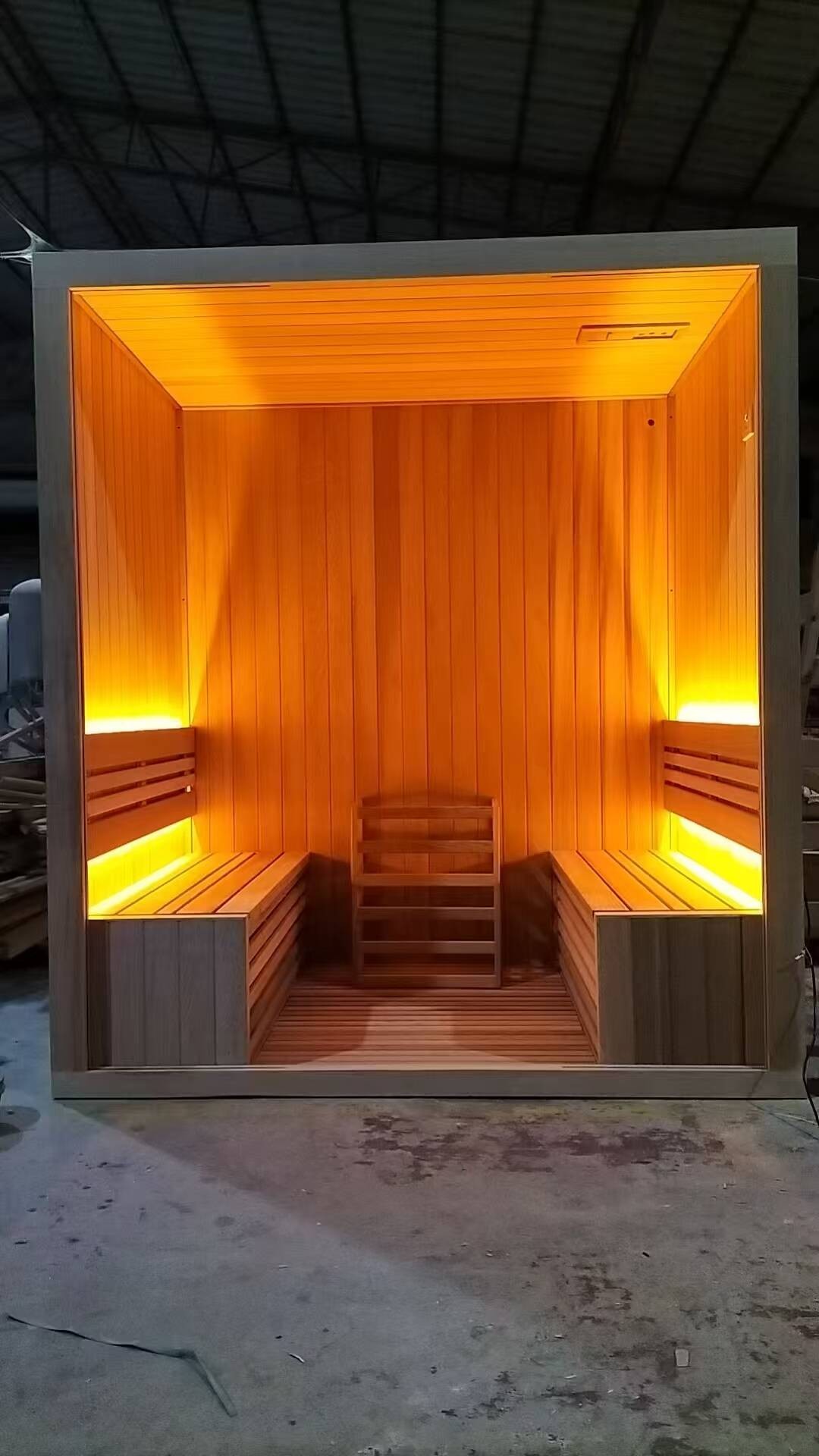 A sauna room unit with its interior lighting switched on.