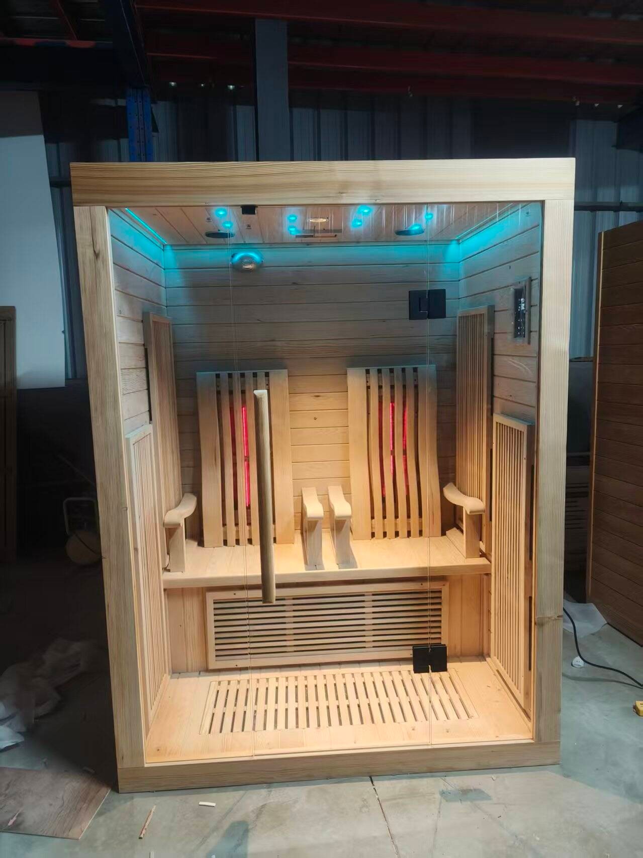A sauna room unit under assembly, seen from the side.
