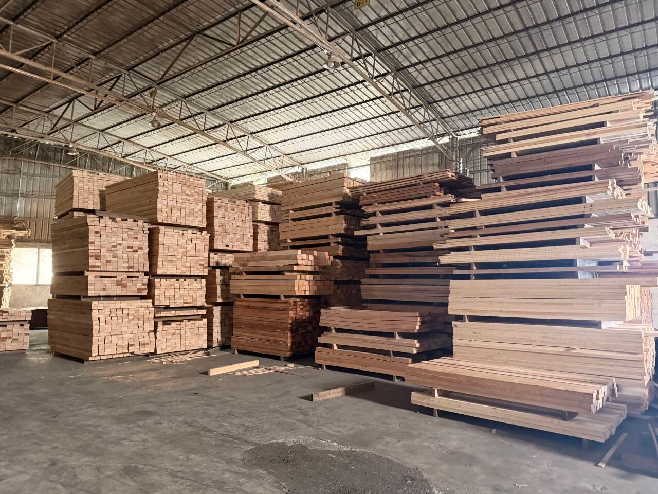 Stacked timber in the SENYA material store.